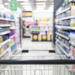 A distorted, layered image of a supermarket scene with overlapping text and visual elements, creating a sense of confusion and sensory overload in a busy public space.