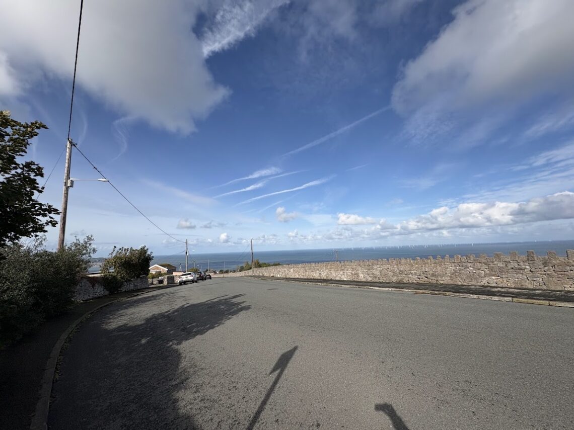 View from Llysfaen towards the sea beneath a wide blue sky