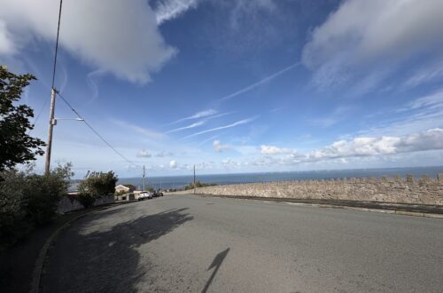 View from Llysfaen towards the sea beneath a wide blue sky